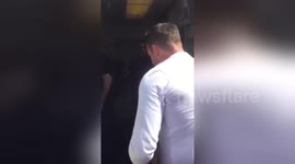 Newsflare Edit - Man entering plane with huge boarding pass