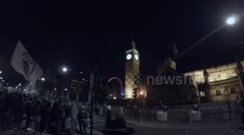 Million Mask March protestors wearing Anonymous mask in London near Big Ben