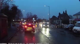 Cyclist goes over handlebars after riding into pothole
