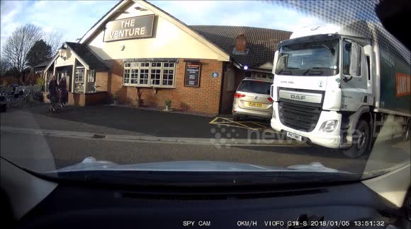 Mature lady struggles to reverse from a parking space, even though there is plenty of room to exit the space next to a parked hgv