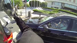 Driver is so interested in a motorcycle, that he doesn't see a light change