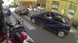 Excited chicks wave at a rider from their car