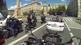 German riders in Warsaw get a photoshoot from a following car