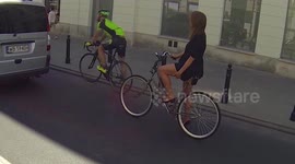 Hot chick on a bicycle pulls her dress up in front of the camera