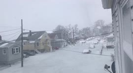 Parked cars trapped in frozen floodwater during US 'bomb cyclone'