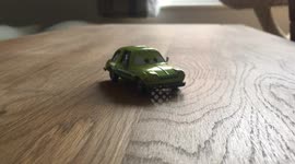 Cat paw sends toy car flying