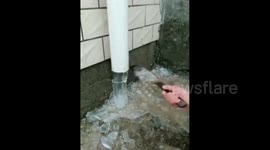 Ice falling from drainpipe is mesmerising