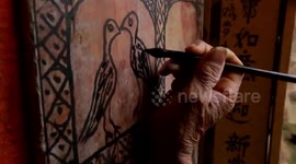 Octogenarian paints graffiti on house walls