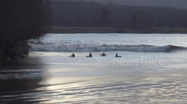 Surfers topple off Severn Bore wave at Minsterworth