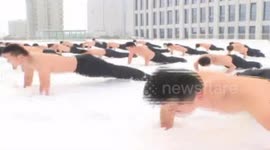Shirtless Chinese soldiers train in snow