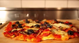 Pizza steaming after being taken out of oven