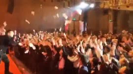 Workers go wild as cash is thrown around in company's party