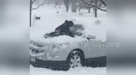 Boy uses his body instead of a brush during Chicago snowstorm