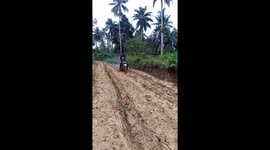 Motorbike riders in uphill struggle along muddle track