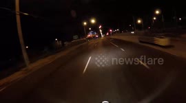 Man circles around intersection on bicycle while swearing.