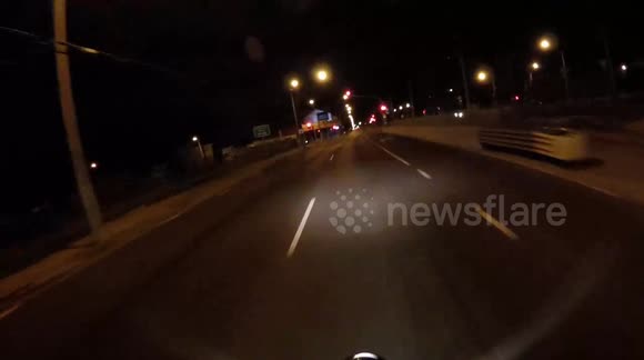 Man circles around intersection on bicycle while swearing.