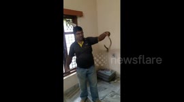 Man finds snake lying on coat rack inside house