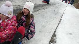 Sisters sledge as snow arrives in Kent