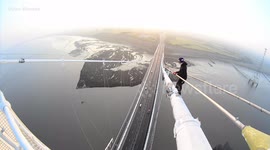 Heart-stopping moment daredevils climb to top of UK bridge