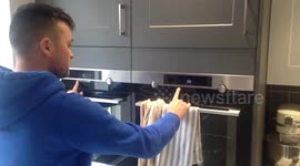 Man with obsessive compulsive disorder setting a clock timer in kitchen