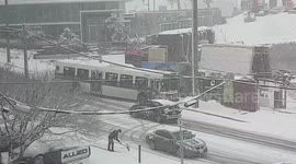 Bus sliding down road in wrong lane during snowstorm
