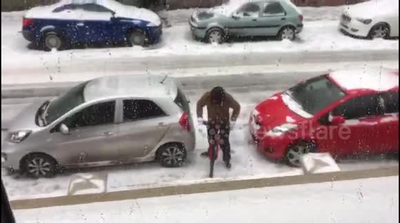 Funny moment man attempts to ride bike on icy UK road