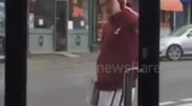 Guy posing and moonwalking in front of a two-way mirror