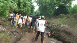 a truck carrying crushed sand in the cold lava of the mountain bromo