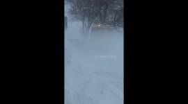 west lothian council gritter has to get passed stuck cars in blizzard storm emma