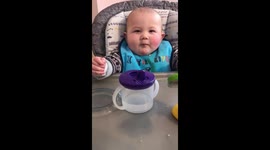 Cute baby blowing raspberry with Mum.