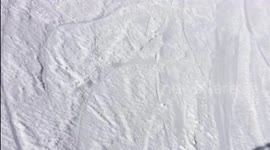 Man tries to jump from a low platform with skis and fails miserably