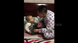 Dad spits gum on baby boy's face when trying to blow a bubble