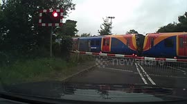 Cyclist nearly hit by train after climbing over barrier