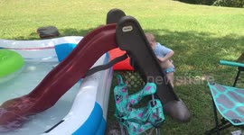 Brother pushes baby sister into water