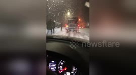 Community spirit: South Yorkshire villagers help push cars in the snow