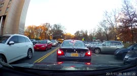 Woman blocks traffic then hits motorcycle