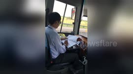 Vietnam bus driver uses TWO hands to make notes while driving on highway