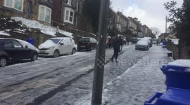 Sheffield residents slide down icy road on way to work