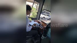 Vietnam bus driver uses TWO hands to make notes while driving on highway