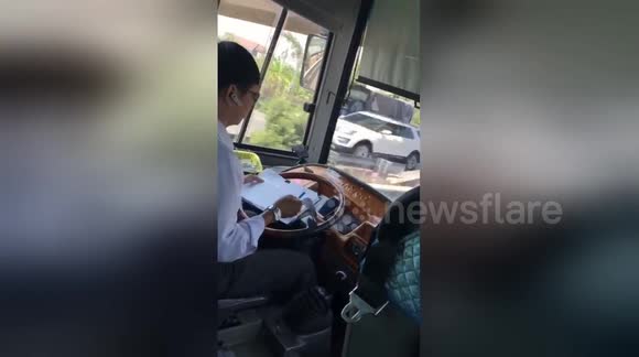 Driver Making Notes Vietnam bus driver uses TWO hands to make notes while driving on ...