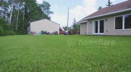 Drone beer delivery to neighbor mowing the lawn on a hot day.