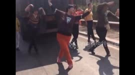 Tourists dance in the street after getting stuck in traffic