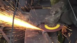 Metalworker sharpening a medieval knife