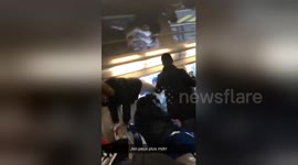 Desperate commuters board train through windows during French rail strike