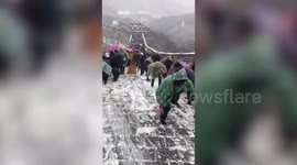 Tourists struggle to walk on snow-covered Great Wall of China