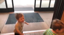 Twins Play With Automatic Door