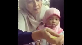Little girl in her mother's hands while eating
