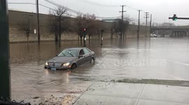 Car drives through flooded New Haven street