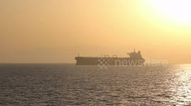 Oil Tankers Fill The Strait Of Hormuz As The Sun Sets