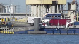 Container ship being loaded on the north bank of the river Thames